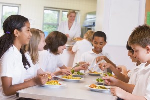 Schoolchildren enjoying their lunch in a school cafeteria