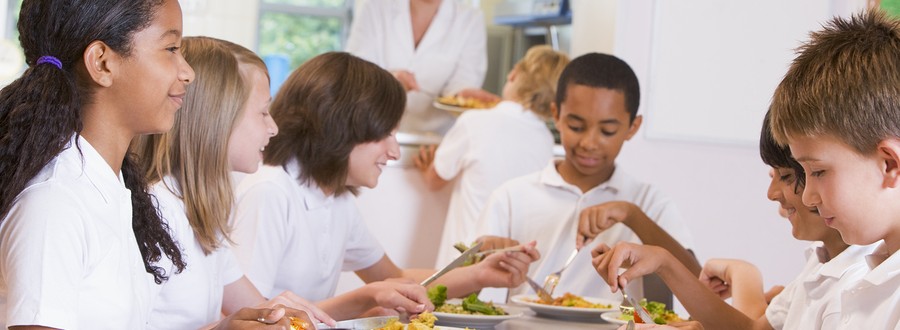 Schoolchildren enjoying their lunch in a school cafeteria